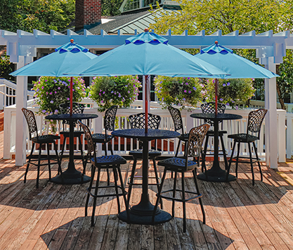 Three blue Frankford Monterey Pulley Lift Market Umbrellas shade tables at an upscale outdoor dining area in Virginia