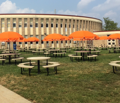 Orange Frankford Laurel Patio Umbrellas shade tables at Cherokee High School in Marlton, New Jersey