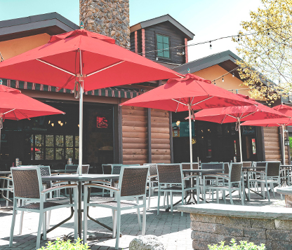 Several red Square Frankford Greenwich Market Umbrellas shade a restaurant's outdoor dining area in New Jersey