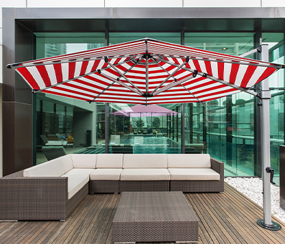 A red and white striped Frankford Aurora Cantilever Umbrella shades a couch at a property in New York